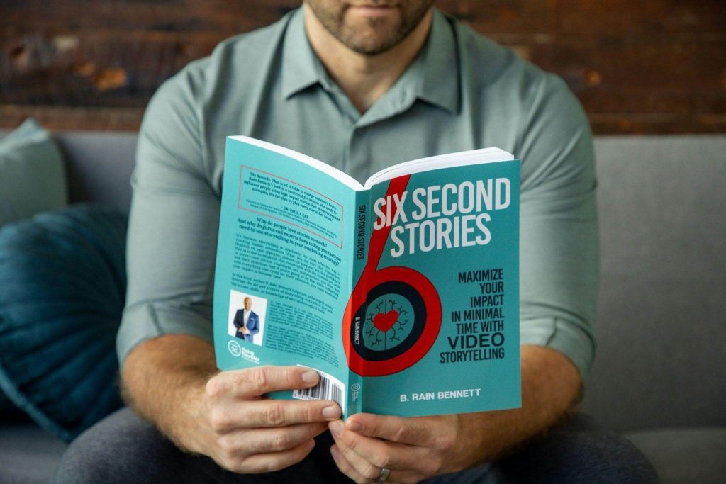 Man reading a book on storytelling to help him feel more confident on stage